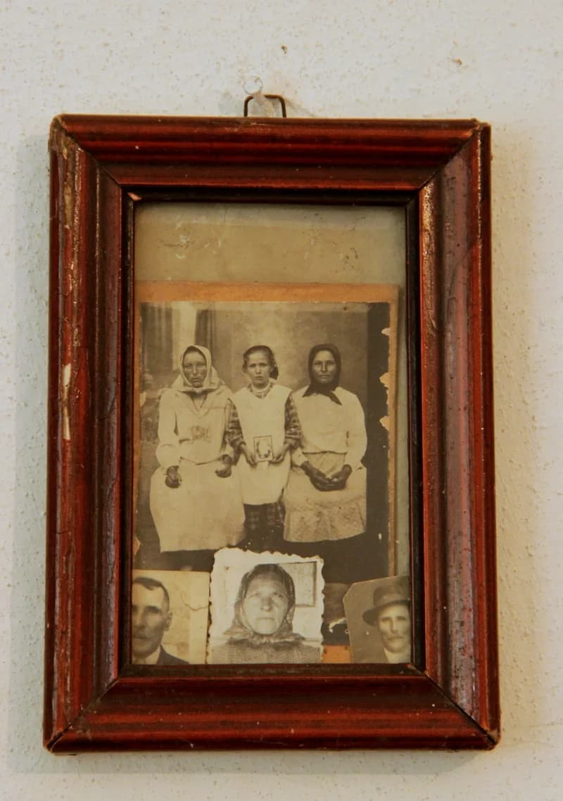 Family photos in a simple wooden frame